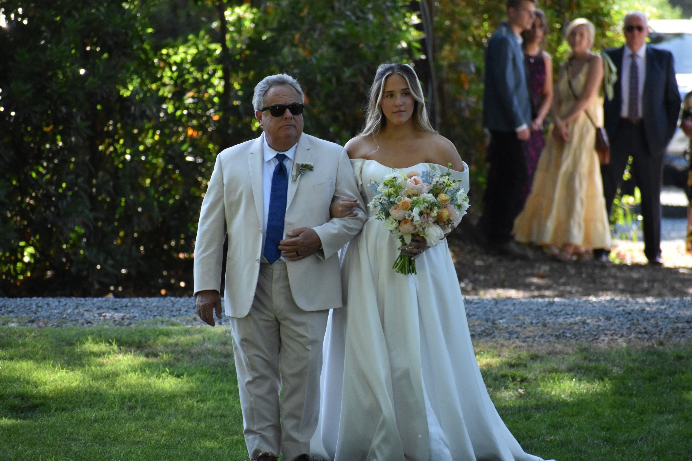 Bride walking down the aisle with father at Fresno wedding ceremony